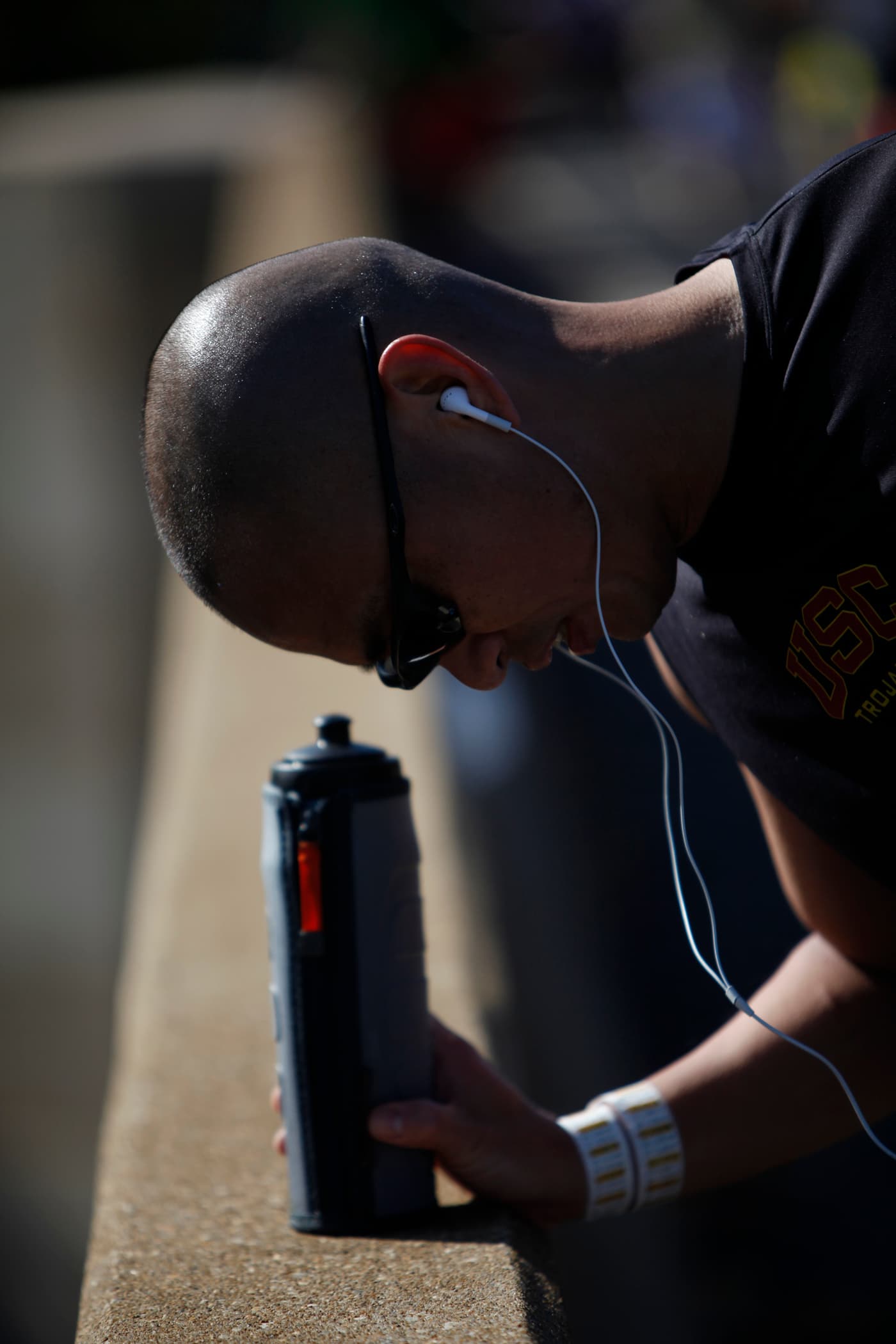 A runner pauses on a road course during the 34th Marine Corps Marathon to stretch his calf and hamstring